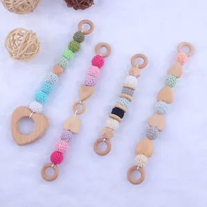 Handmade beech wood baby teether with macaron crochet beads and heart shaped pendant