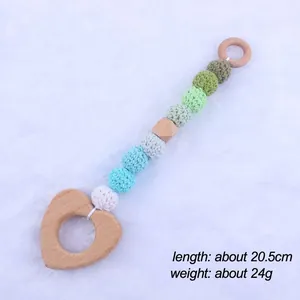Detail of baby teether with beech wood rings, crochet beads, and macaron colors