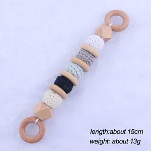 Detail view of beech wood and macaron crochet bead baby teether toy measuring 15cm length