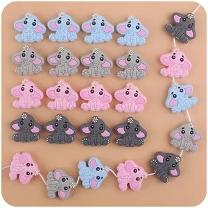 Detailed view of elephant silicone teethers in blue and pink for baby pacifier clips