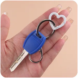 Colorful heart-shaped zinc alloy spring ring hook and keychain accessory set held by hand