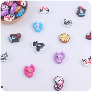 Flat lay of colorful silicone beads with animal and text motifs for DIY pacifier clips