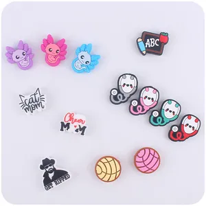 Detailed close-up of various colorful PVC shoe charms with cartoon and slogan designs