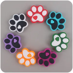 Detailed view of silicone paw-shaped shoe charms in various colors with heart accents