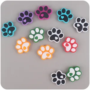 Detailed view of colorful dog paw shoe charms with heart accents for DIY accessories