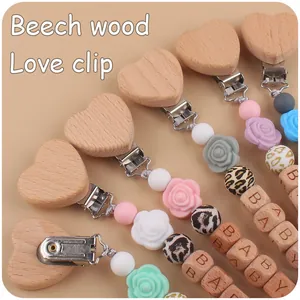 Detail of beech wood heart clip and silicone beads on a pacifier chain for babies