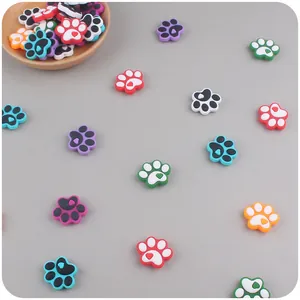 Macro shot of colorful paw-shaped silicone beads with heart details for DIY teething chains