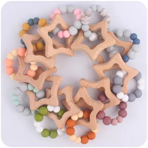 Detail of star-shaped beech wood and colorful silicone bead teething rings for babies