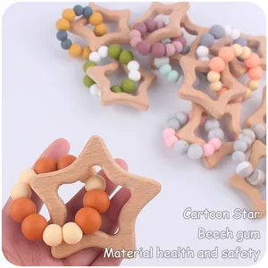 Close-up of star-shaped beech wood ring and colorful silicone beads for baby teething