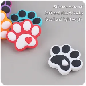 Detail of colorful silicone paw-shaped charms with heart designs for baby pacifier clips