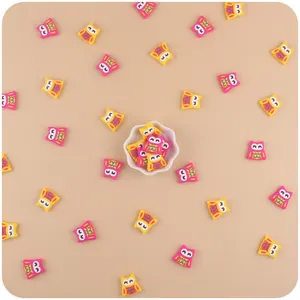 Macro view of cute cartoon owl teething beads in yellow and rose pink for DIY baby pacifiers
