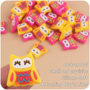 Close-up of yellow and pink silicone owl beads for baby teething accessory DIY
