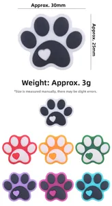 Detailed view of dog paw charms with heart patterns in multiple vibrant colors