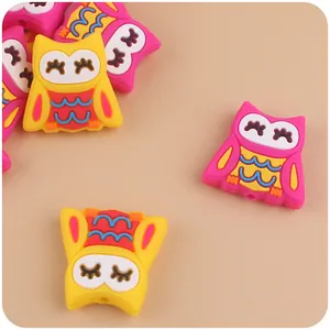 Detail of colorful owl silicone beads with threading holes for DIY baby teether chains