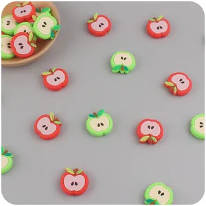 Detailed view of red and green silicone apple charms for baby pacifier clips