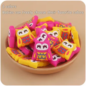 Cartoon owl silicone beads in yellow and pink displayed in a wooden bowl for baby DIY
