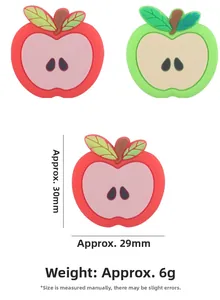 Detail view of red and green apple silicone teether with size dimensions 30x29mm