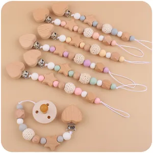 Vue à plat des attaches-tétines avec cœurs en bois, perles silicone et détails au crochet