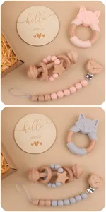 Detail view of pink and grey silicone fox teething toy set with beech wood rattles