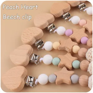 Detail of beech wood heart clips and pastel silicone beads for DIY baby pacifier chains