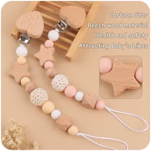 Detail of baby pacifier clip with star-shaped beech wood beads and braided textures