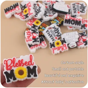Detail of silicone shoe charms with Blessed MOM and Sunflower designs for DIY baby accessories