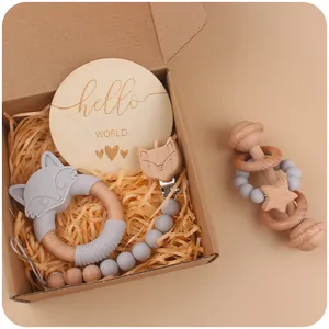 Baby gift set with silicone fox teether, wooden rattle, and pacifier clip in a box