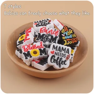 Close-up of 7 silicone shoe charms featuring MAMA and coffee themes in a wooden bowl