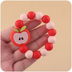 Baby teething bracelet set featuring red apple silicone beads for infant sensory play