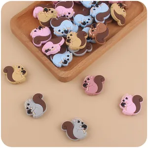 Detailed macro view of colorful squirrel silicone beads in a wooden tray for DIY clips