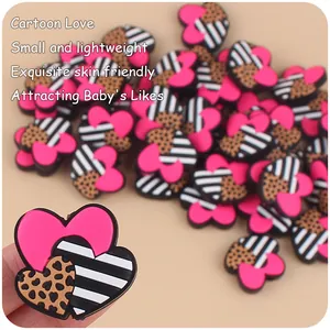 Macro detail of silicone heart beads with leopard print and stripes for DIY pacifier chains