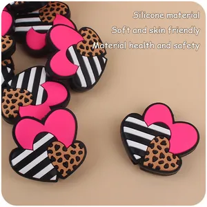 Detail of soft heart-shaped silicone beads with pink, striped, and leopard print patterns