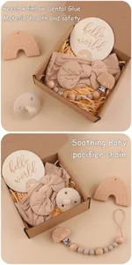 Close-up of baby gift set with rainbow wood teether, pacifier clip, and bow headband