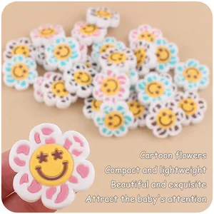 Close-up of colorful cartoon flower silicone beads with smiley faces for DIY baby pacifier clips