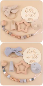 Detailed view of baby gift set including star beechwood teether and bow headband