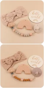 Detail of baby gift set with rainbow wood teether and knitted bow headband in earthy tones
