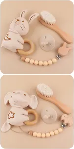 Detail view of baby nursery set featuring lion wooden rattle and soft hair brush