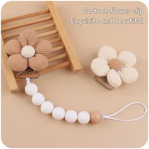 Detail of cartoon flower pacifier clip with corduroy petals and silicone wooden beads