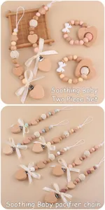 Detail of wooden pacifier chain and heart teether set with crochet and silicone beads