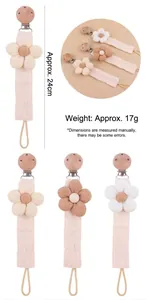 Detail of floral cotton pacifier chain with beech wood clip measuring 24cm in length