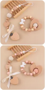 Detail of baby pacifier clip and wooden heart teether with handmade crochet beads