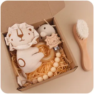 Baby gift set with cartoon lion plush, silicone pacifier, wooden rattle, and brush