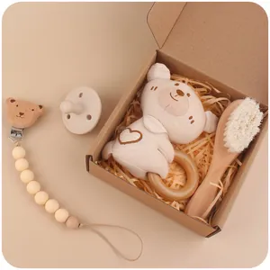 Baby gift set with crochet bear rattle, wooden brush, pacifier clip and silicone soother