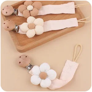 Handmade baby pacifier clip with corduroy flower and beech wood clip in soft neutral colors