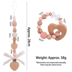 Pink and white handmade baby pacifier clip and wooden heart teething ring gift set
