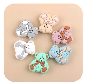 Detailed view of colorful bear-shaped silicone teether beads for DIY pacifier clips