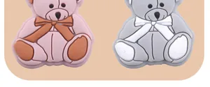 Macro shot of cartoon bear silicone beads for DIY pacifier clips in pink and grey colors