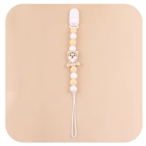 Close-up of baby pacifier clip with silicone beads and a cute cartoon animal charm