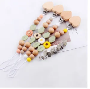 Detail of wooden heart clips and silicone daisy beads for pacifier chain set