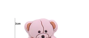 Detail view of pink cartoon bear silicone charm showing 3cm size and soft 3D texture